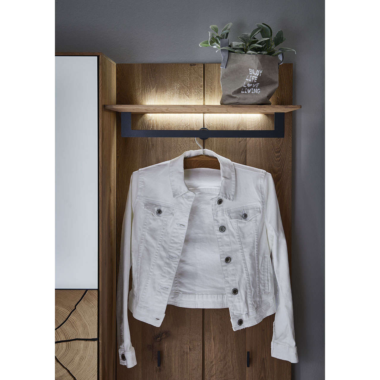 Detailaufnahme der Wandgarderobenbeleuchtung an der Hutablage mit Metallstange vom Garderobenpaneel CAYA 7140-9061 aus massiver Kerneiche.