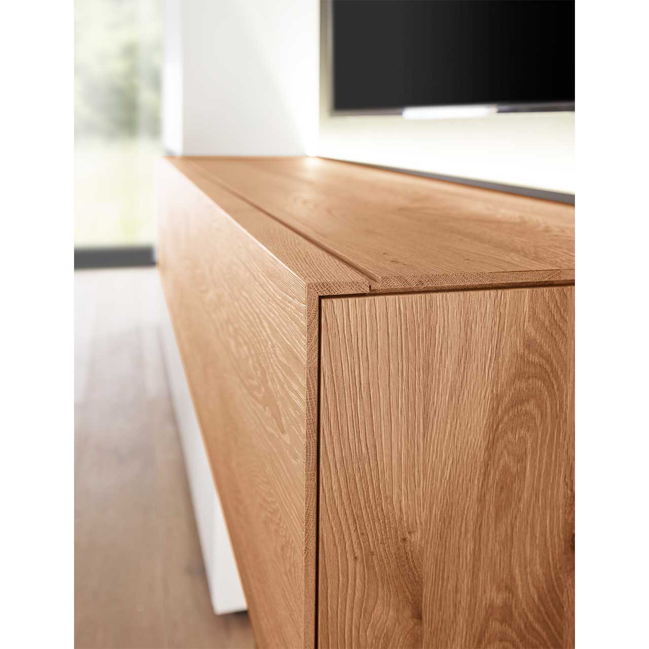 Detailansicht der Kante des langen, rechteckigen Hängelowboards Nr. 2215 aus massiver Kerneiche Umato mit sichtbarer edler Holzmaserung.