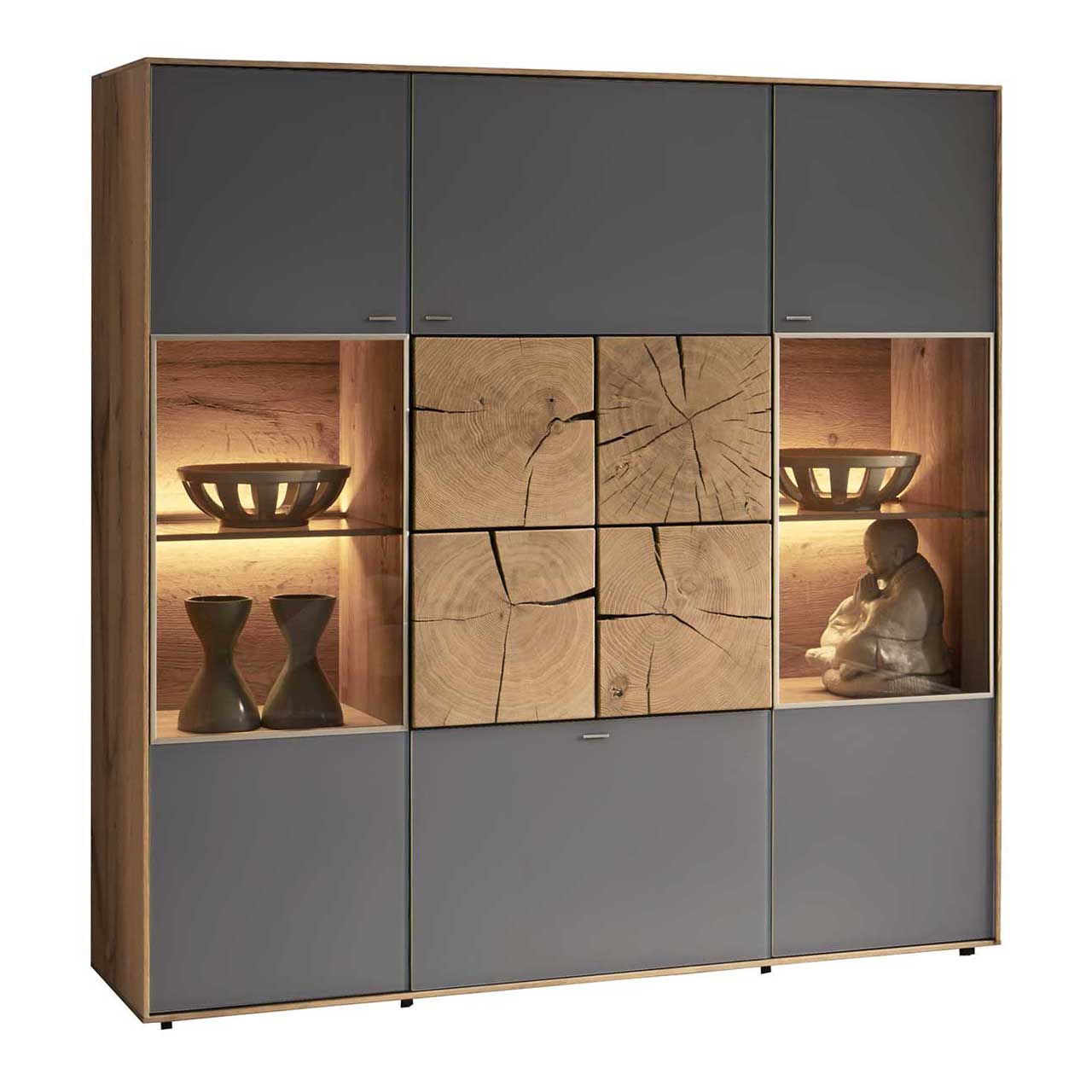Hartmann CAYA - Highboard 7170-7134A Modernes Highboard aus massiver Kerneiche Umato mit Mattglas anthrazit Fronten, rechts und links mit beleuchtetem Glasausschnitt, mittig mit vier dekorativen, rechteckigen Hirnholzscheiben in heller Kerneiche Umato.