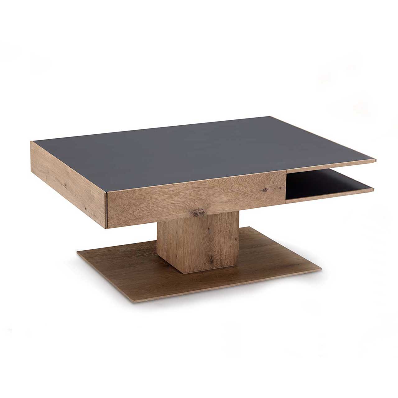 Hartmann CAYA - Couchtisch 7170-0446 Moderner, rechteckiger Couchtisch aus massiver Kerneiche Umato. Dicke Tischplatte in Mattglas anthrazit mit integriertem Schubkasten und seitlichem Ablagefach, auf massiver, rechteckiger Holzsäule und Bodenplatte stehend.
