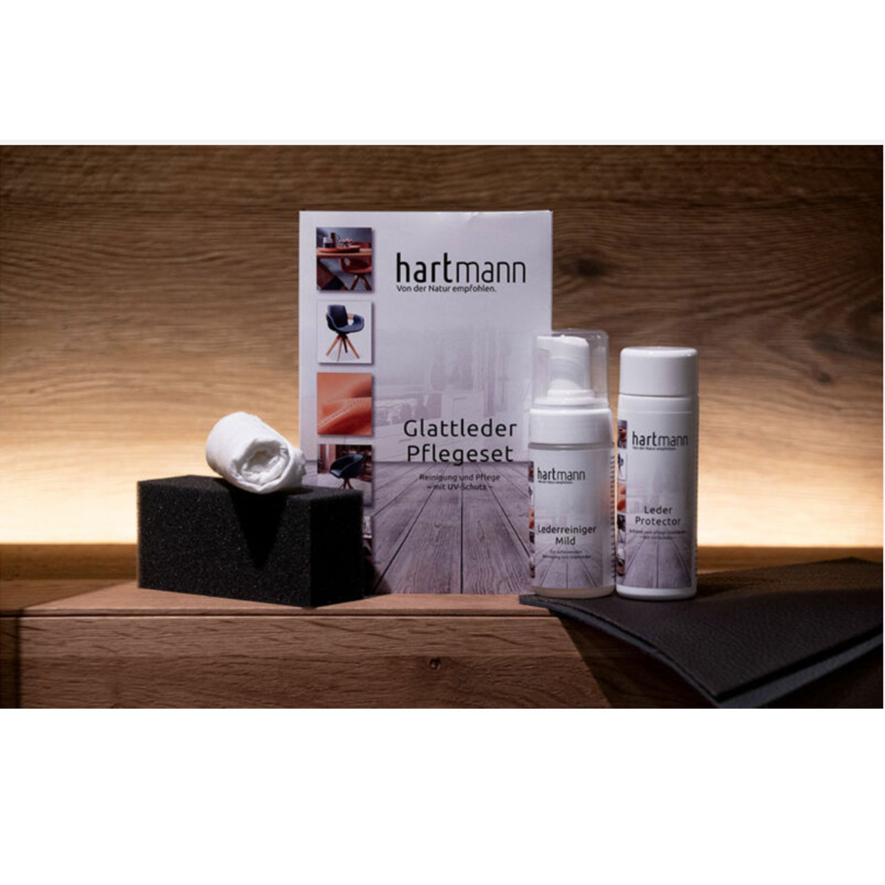 Vierteiliges Pflegeset für Lederbezüge, bestehend aus Lederreiniger, Leder Protektor, Reinigungsschwamm und Pflegetuch.