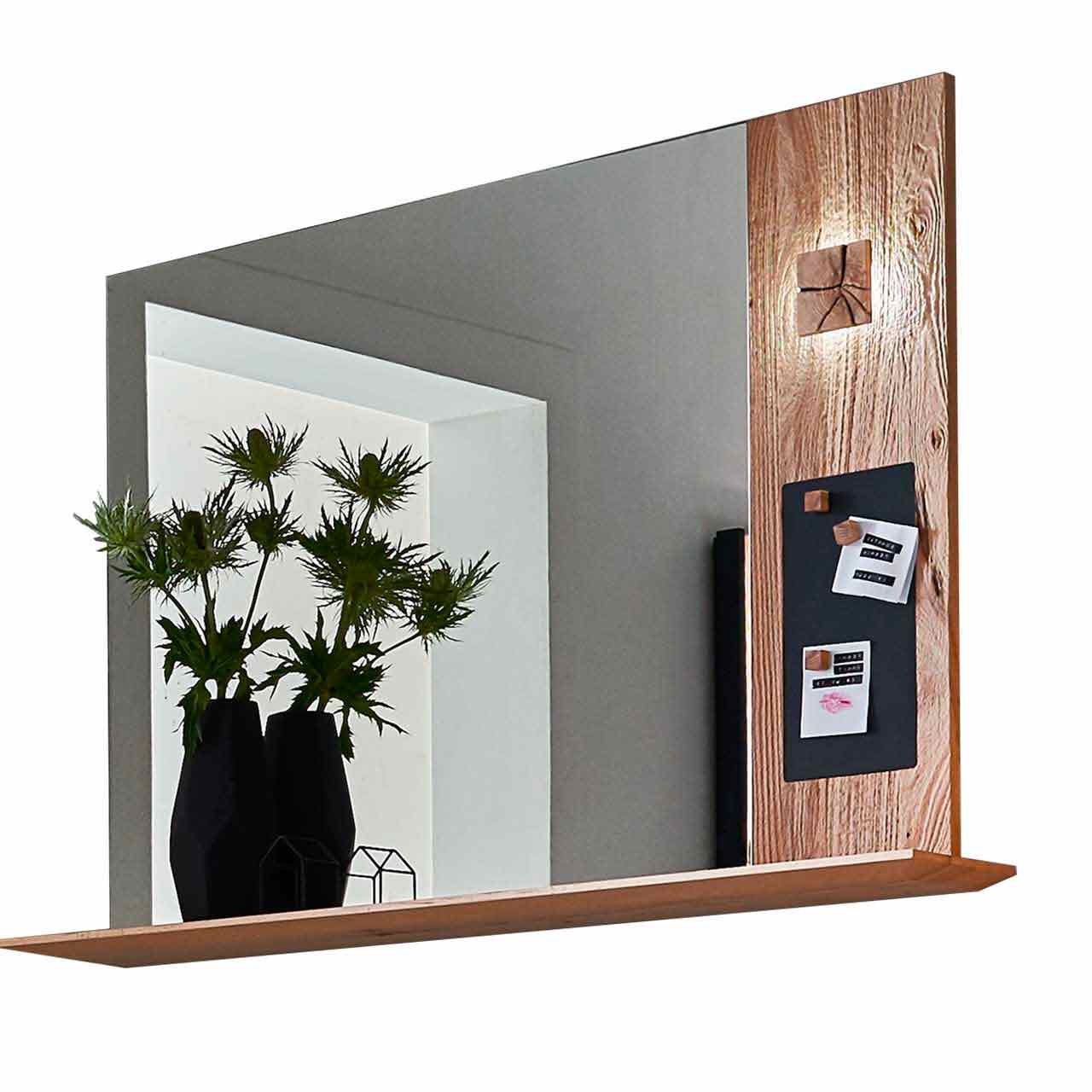 Modernes Wandpaneel aus massiver Kerneiche Umato mit großem Spiegel mit darunter verlaufendem Ablageboden aus Holz. Rechts Holzapplikation mit dekorativen, beleuchteten Hirnholzscheiben und einer kleinen Metalltafel. 