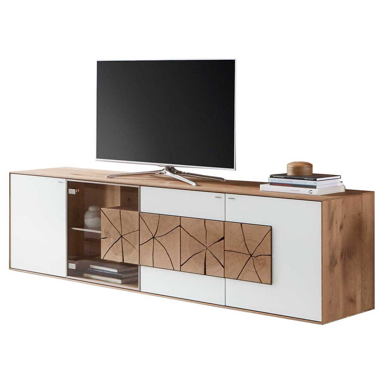 Lowboard aus Kerneiche Umato mit weißfarbenen Mattglasfronten, rechts mit drei rechteckigen Hirnholzscheiben, links mit Glastür, beleuchtetem Glasboden und Hirnholzblock.