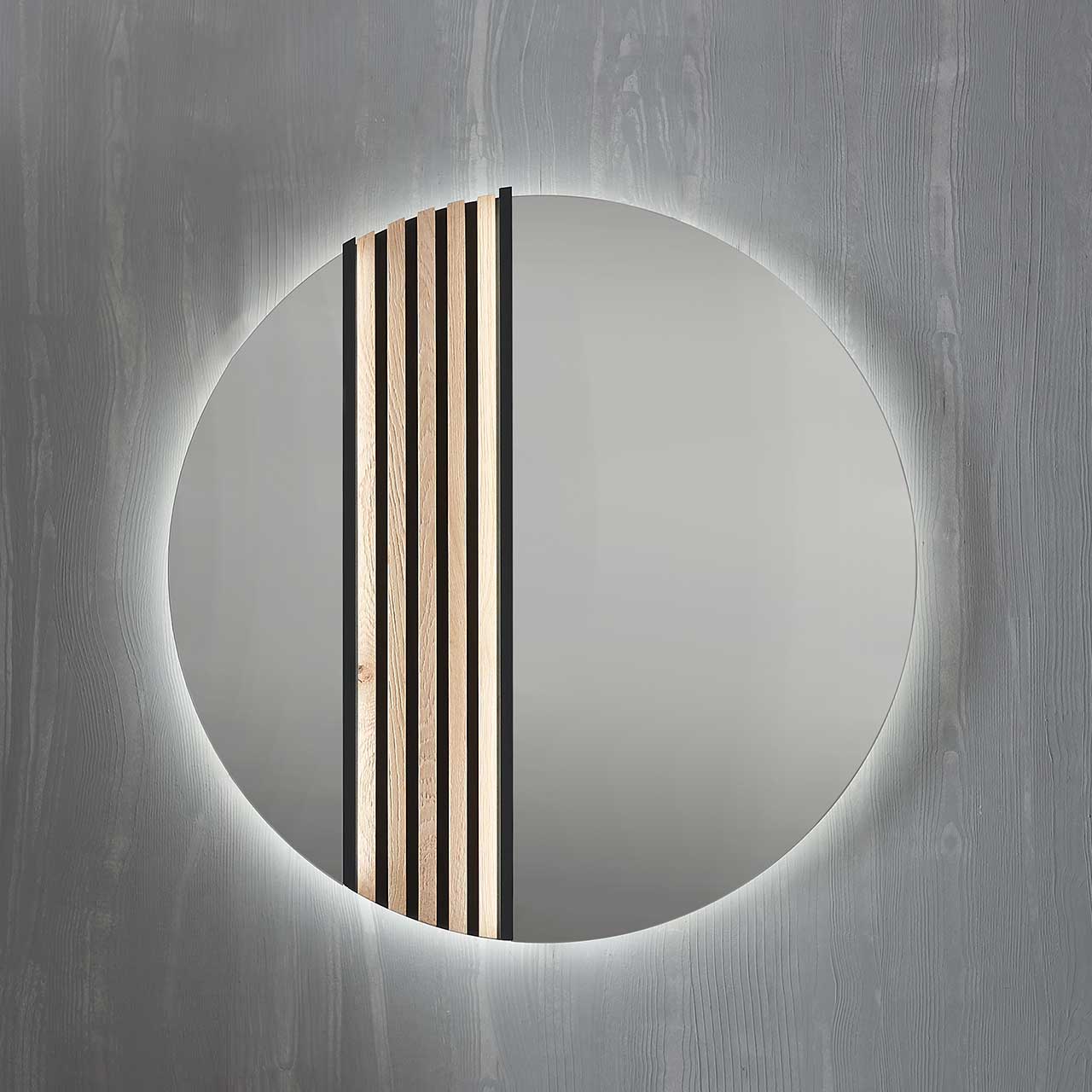 Hartmann SALVO Garderoben - Wandspiegel 8550G-5097 li - mit Lamellen Moderner runder Wandspiegel, links mit Lamellen-Akzent eingefasst in einen anthrazitfarbenen Metallrahmen.