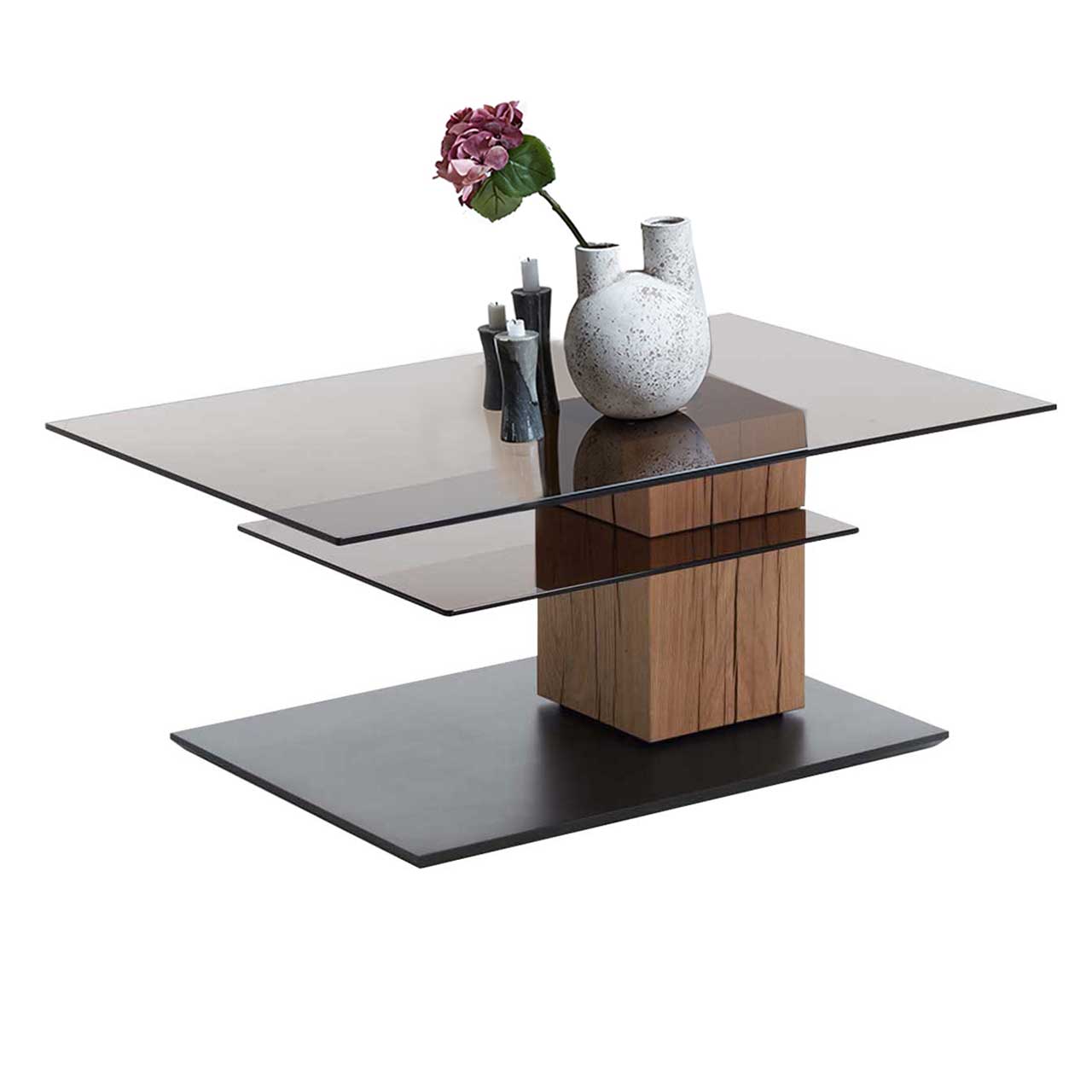 Edler Couchtisch mit drehbarer, rechteckiger Glasplatte und zusätzlicher fester Glasablage darunter. Massive Holzsäule aus Riffholz auf dunkler Bodenplatte.